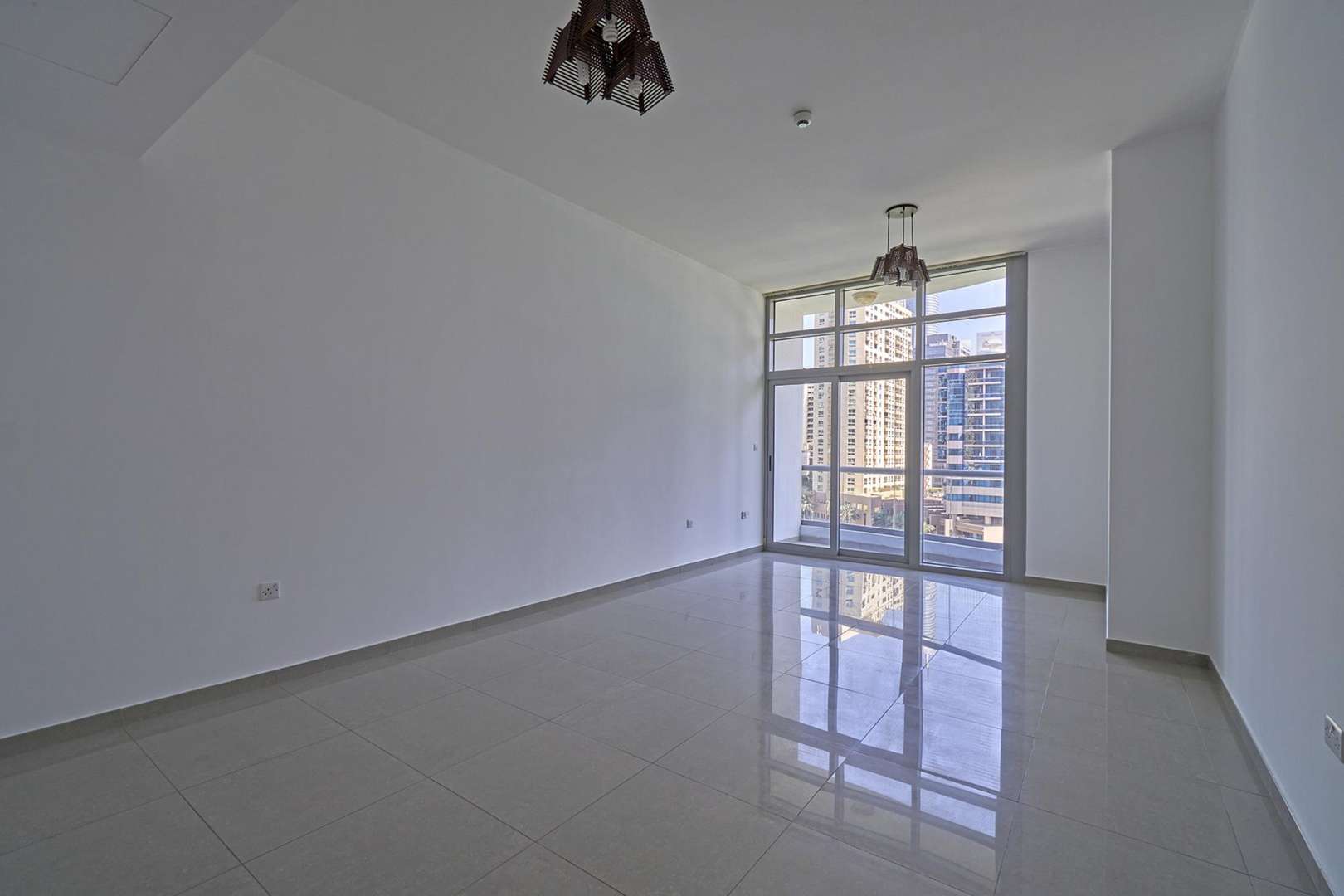 Bright living room with large windows in Dubai Marina apartment for rent