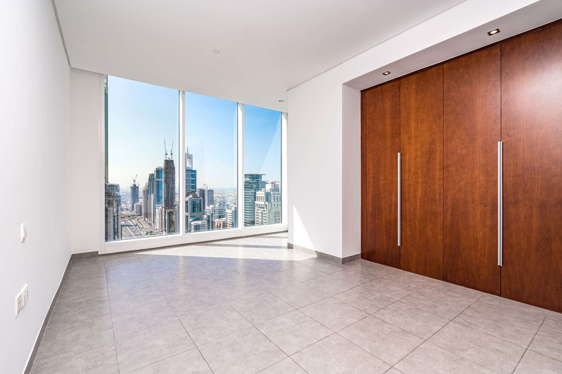 Empty living room with large windows and city views, Maze Tower, DIFC apartment