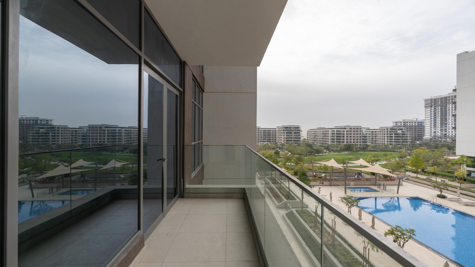 Empty living room with large windows in Dubai Hills Estate apartment for rent