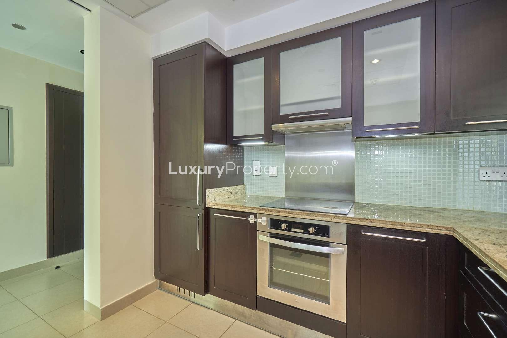 Modern open-plan living area with kitchen in 2-bedroom Mosela apartment, The Greens