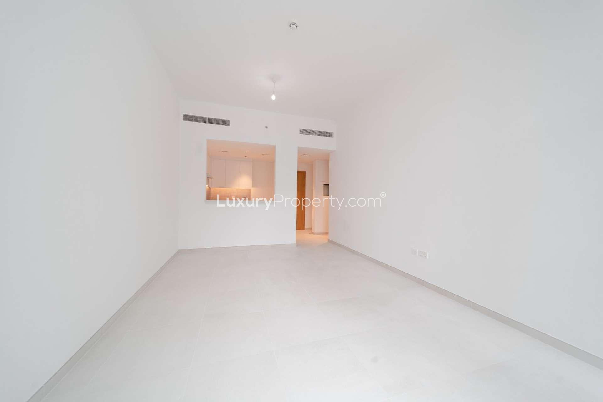 Empty living room with large windows in Mudon Views 2-bedroom apartment