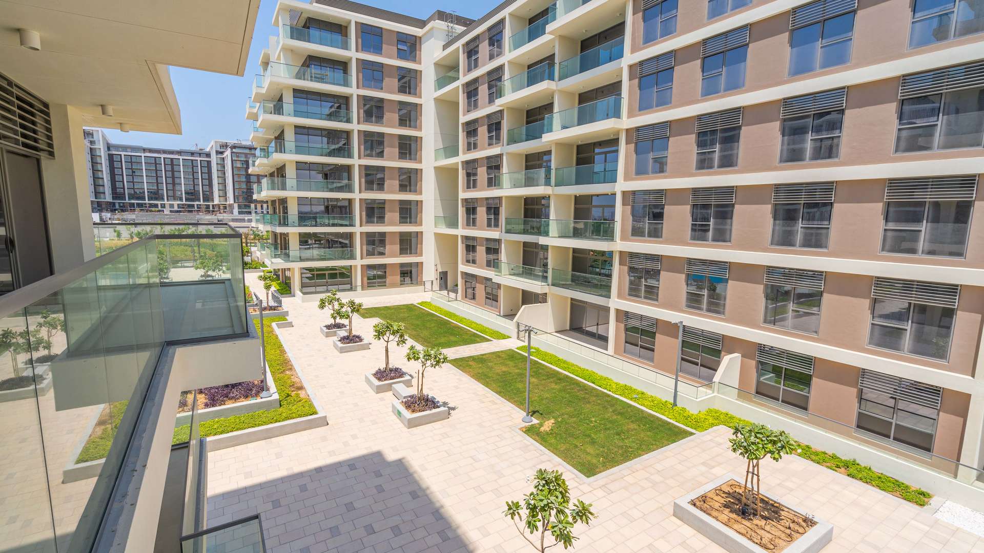 "View of modern apartment complex courtyard in Mulberry, Dubai Hills Estate, Park Heights.",Luxurious bathroom with dual sinks in 2-bedroom apartment, Mulberry, Dubai Hills Estate