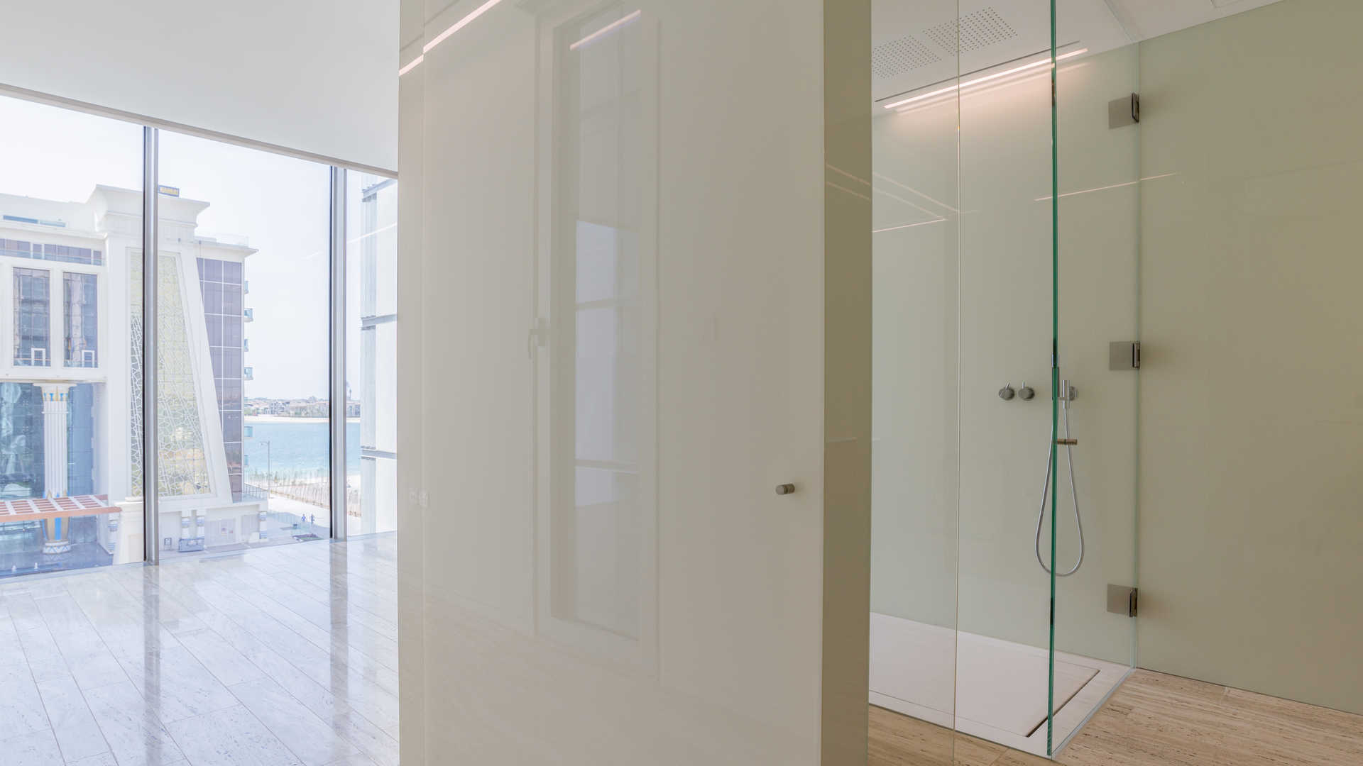 Modern shower and floor-to-ceiling windows in Muraba Residences apartment, Palm Jumeirah