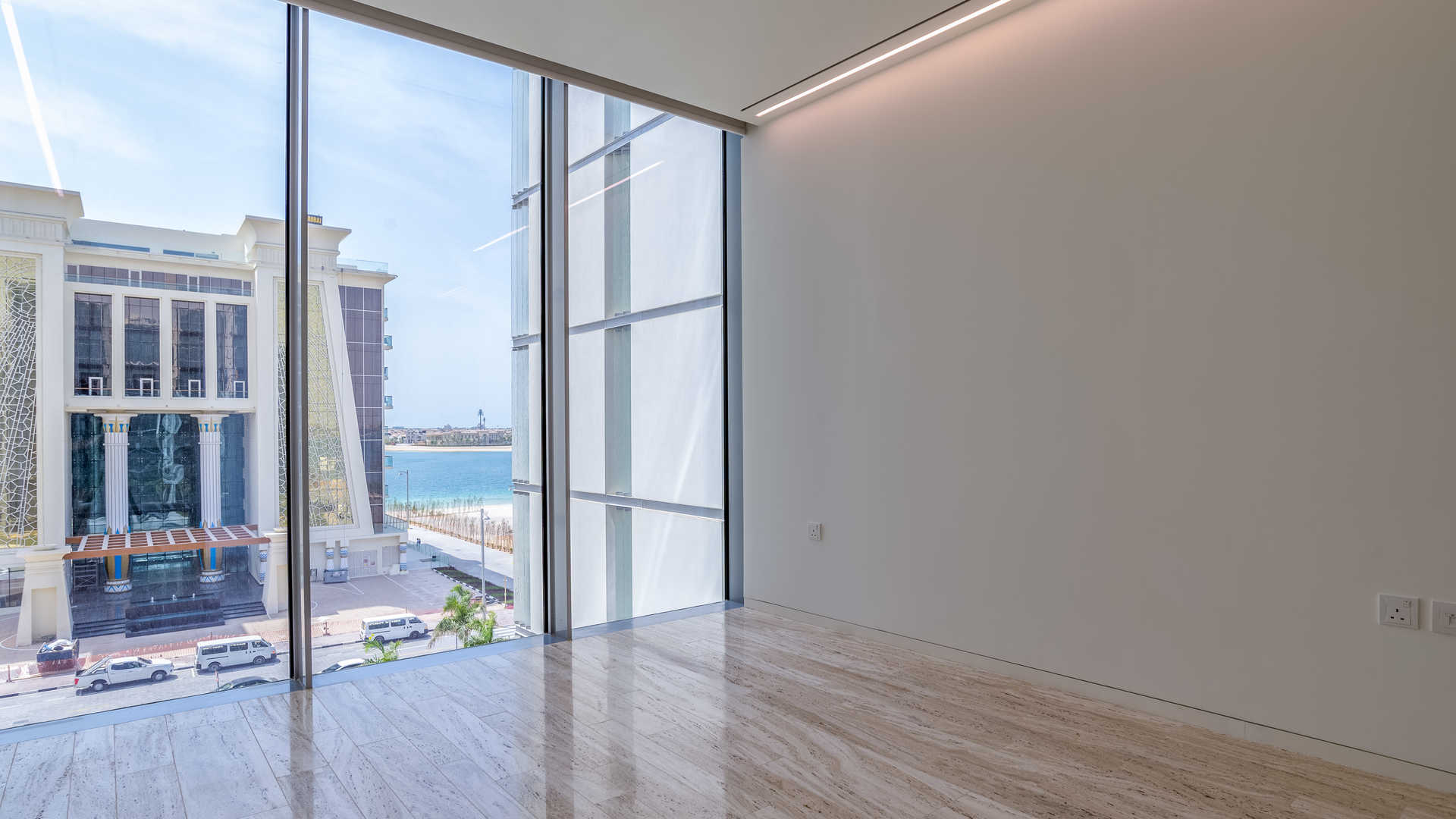 "Stunning ocean view from Muraba Residences apartment balcony, Palm Jumeirah, The Crescent.",Bright room with large windows and sea view in Muraba Residences, Palm Jumeirah