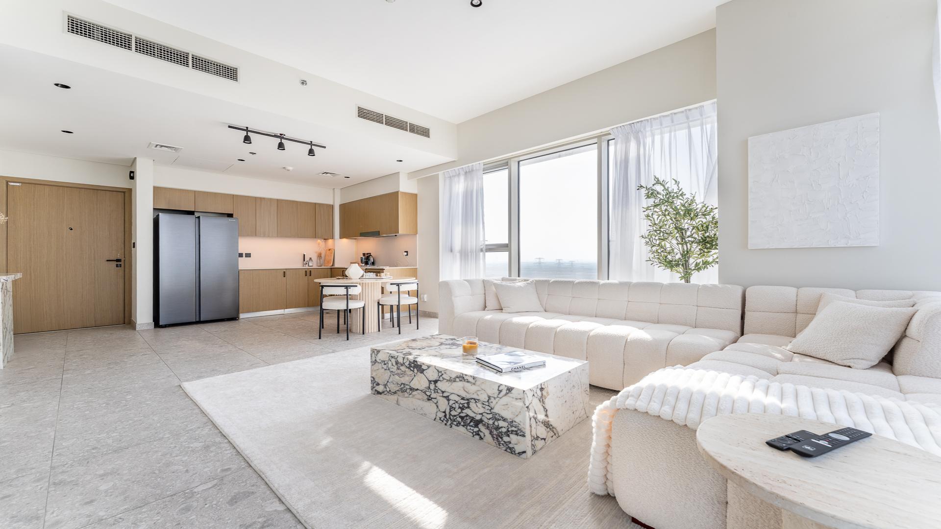 Modern living room in Golf Suites apartment, Dubai Hills Estate, with large windows and stylish decor