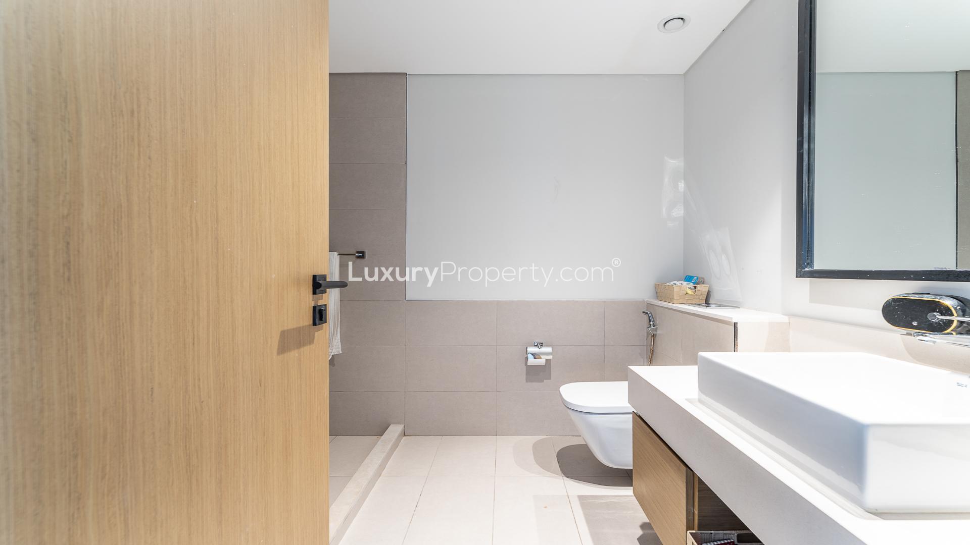 Furnished bedroom with polka dot bedding in Dubai Hills Estate apartment for rent