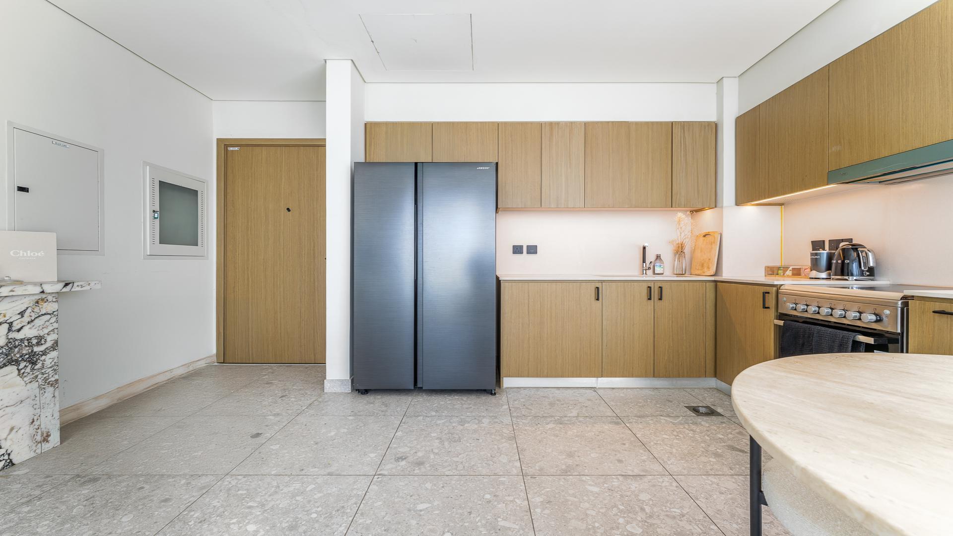 Modern living room in Golf Suites apartment, Dubai Hills Estate, with elegant decor and large windows