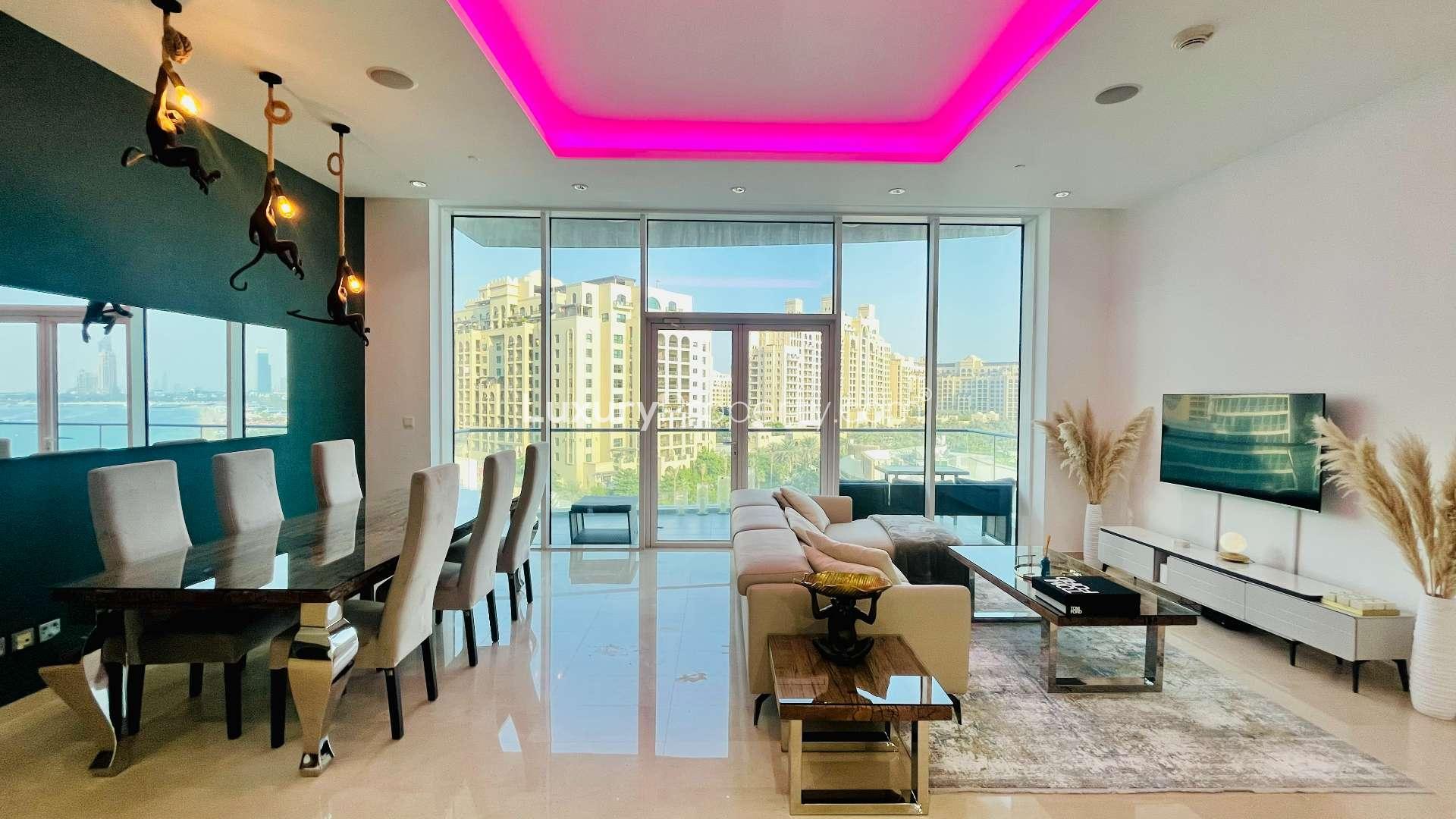 Refurbished Palm Jumeirah apartment living room with sea view, modern decor, and large windows