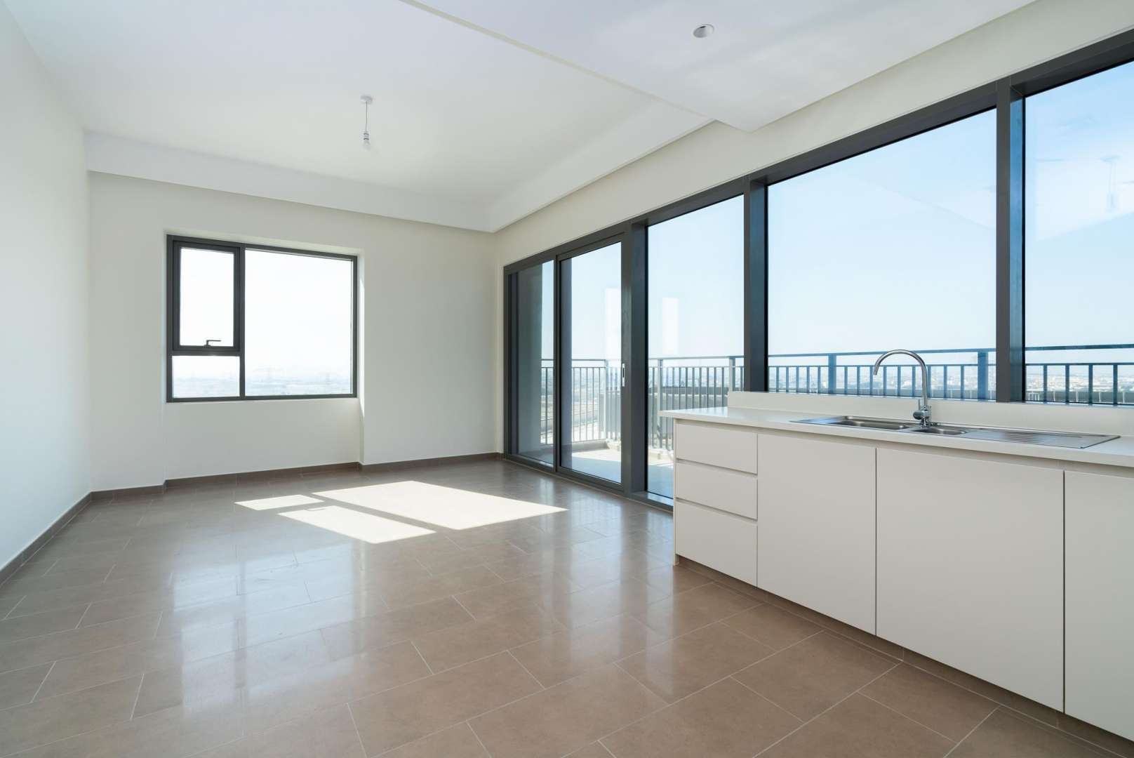 Modern kitchen with large windows, Dubai Hills Estate apartment, view of Burj Al Arab