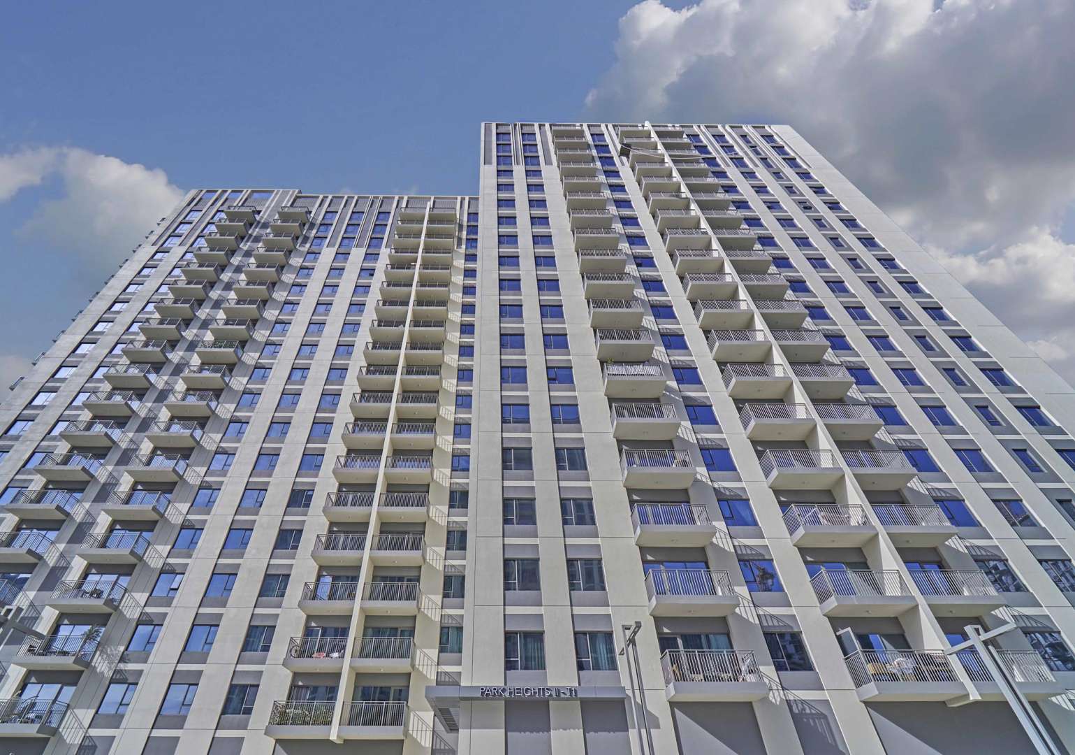 "High-floor apartment balcony view in Park Heights, Dubai Hills Estate for rent.",High-floor apartment building exterior in Park Heights, Dubai Hills Estate, for rent