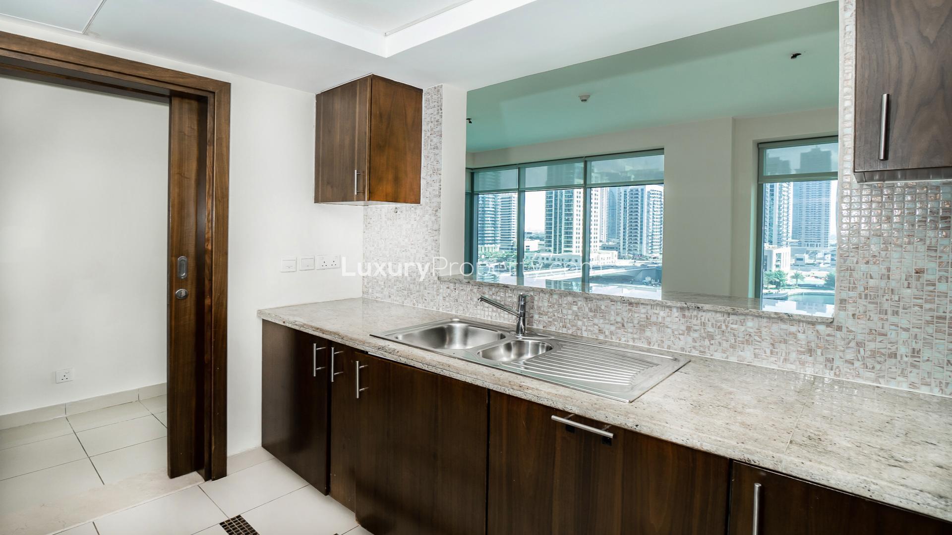 "Modern kitchen with granite countertops and marina view in Park Island apartment, Dubai Marina.",Dubai Marina apartment balcony with stunning waterfront and skyline view, Park Island rental