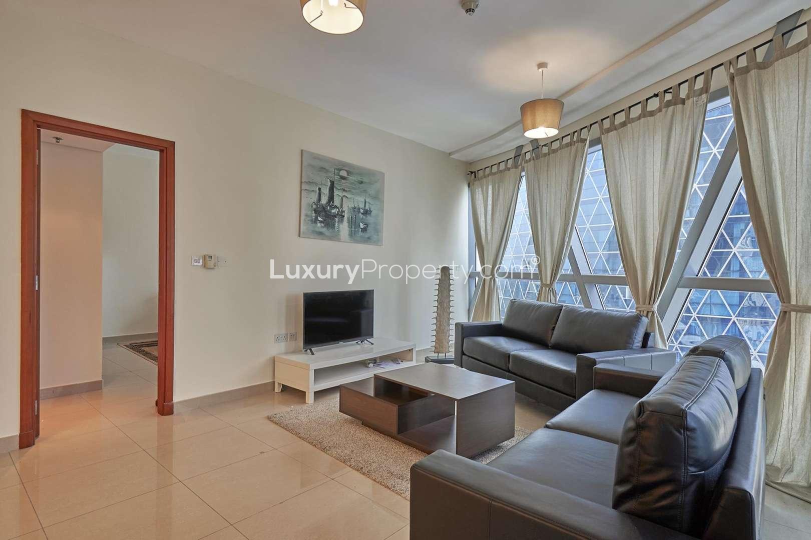 Park Towers exterior in DIFC, Dubai; modern architecture with palm trees and blue sky