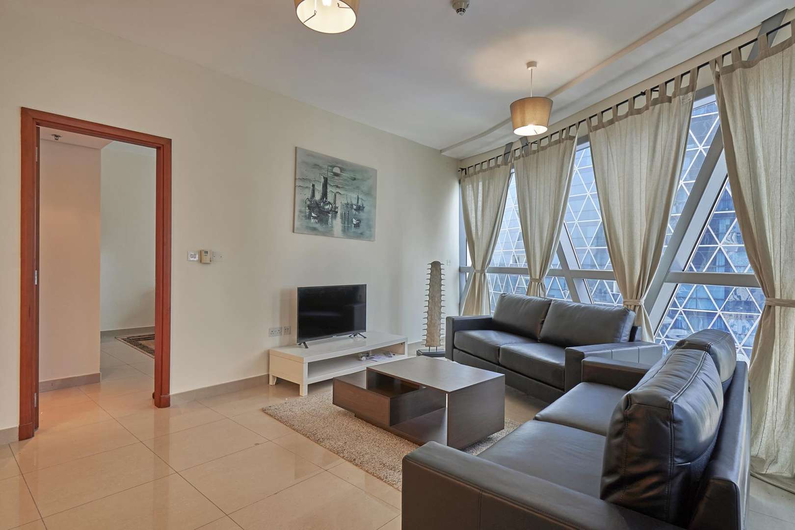 Park Towers exterior in DIFC, Dubai; modern architecture with palm trees and blue sky