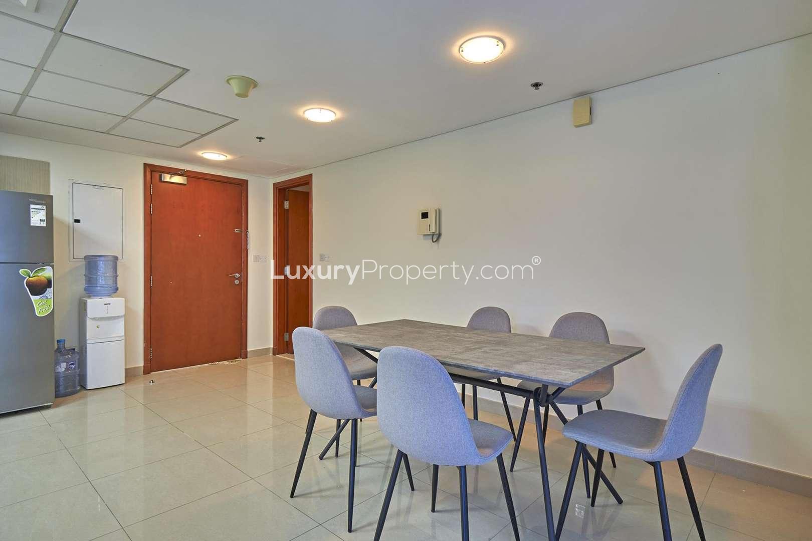 Bright living room in DIFC Park Towers apartment with city views through large windows