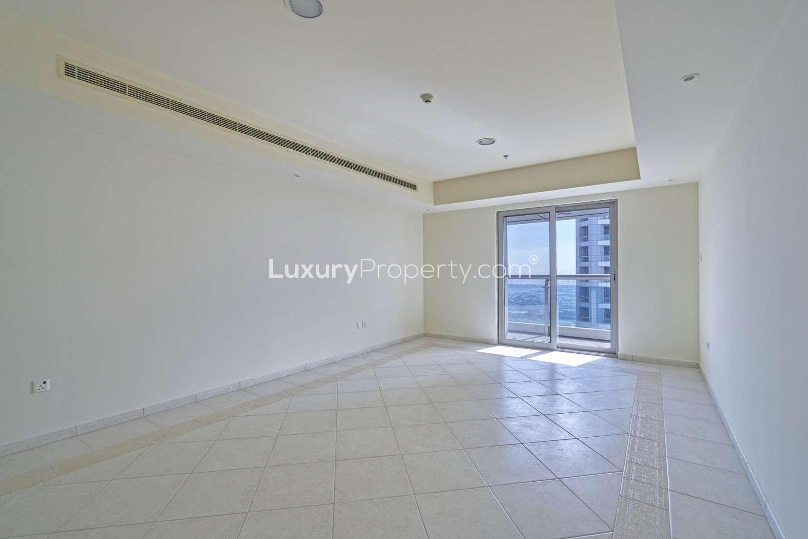 Empty living room with large window in Princess Tower, Dubai Marina apartment for rent