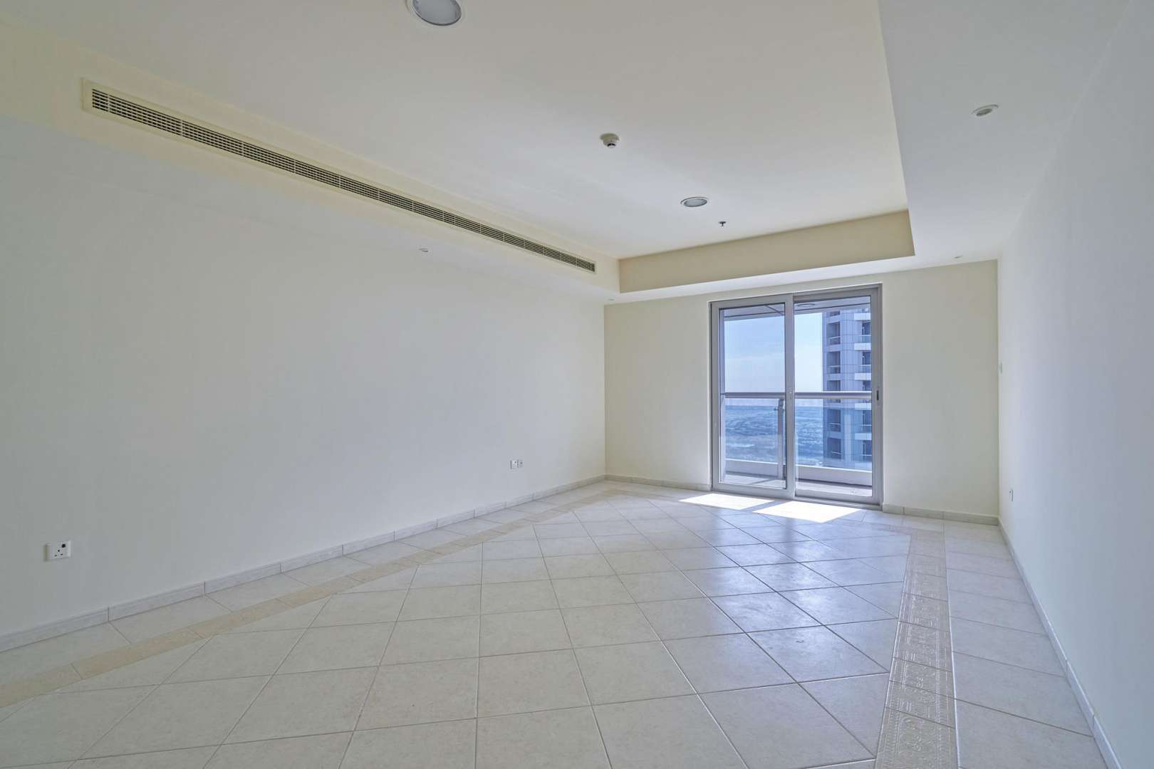 Empty living room with large window in Princess Tower, Dubai Marina apartment for rent