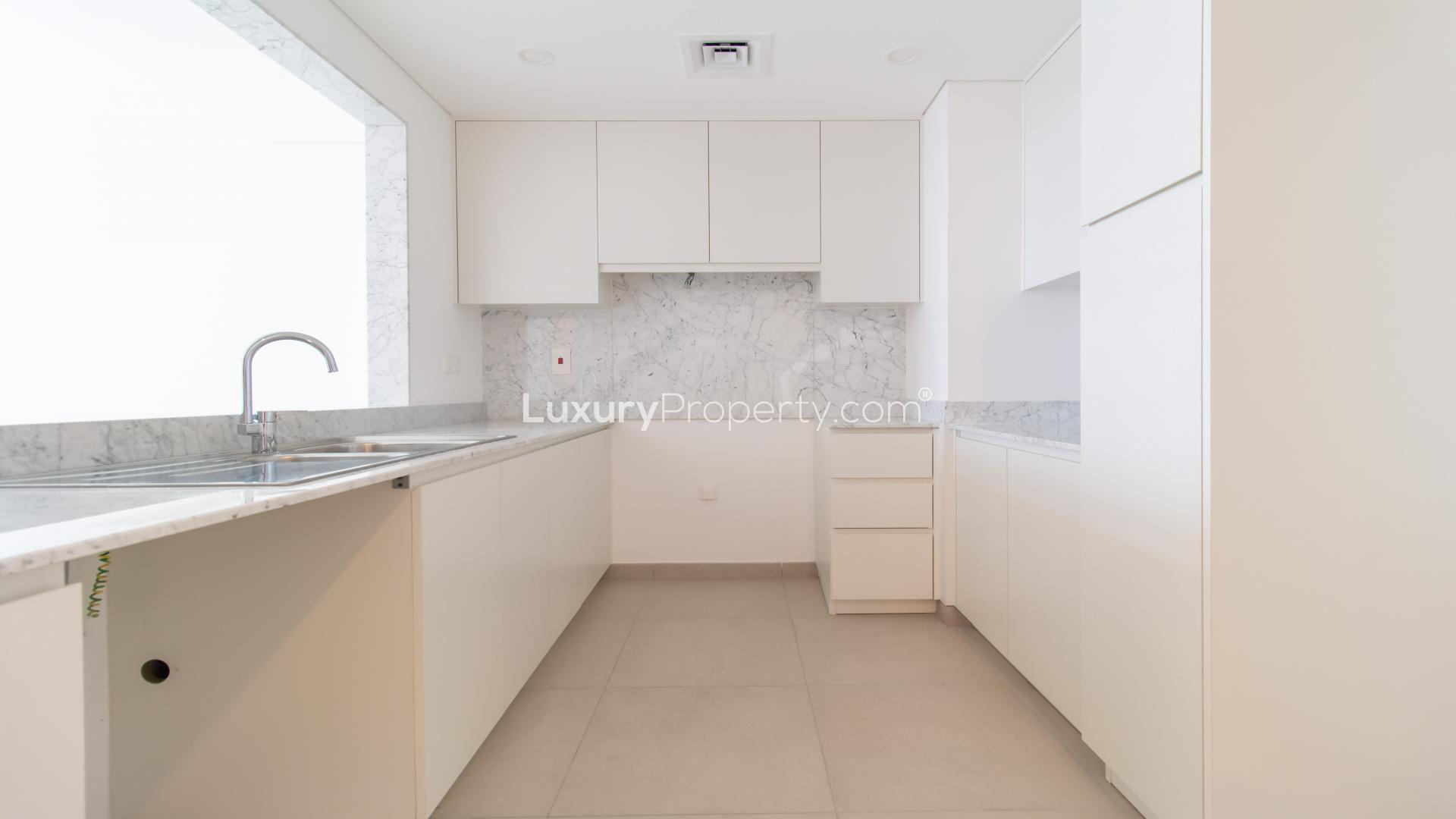 Empty bedroom with wooden closet in Madinat Jumeirah apartment, Dubai
