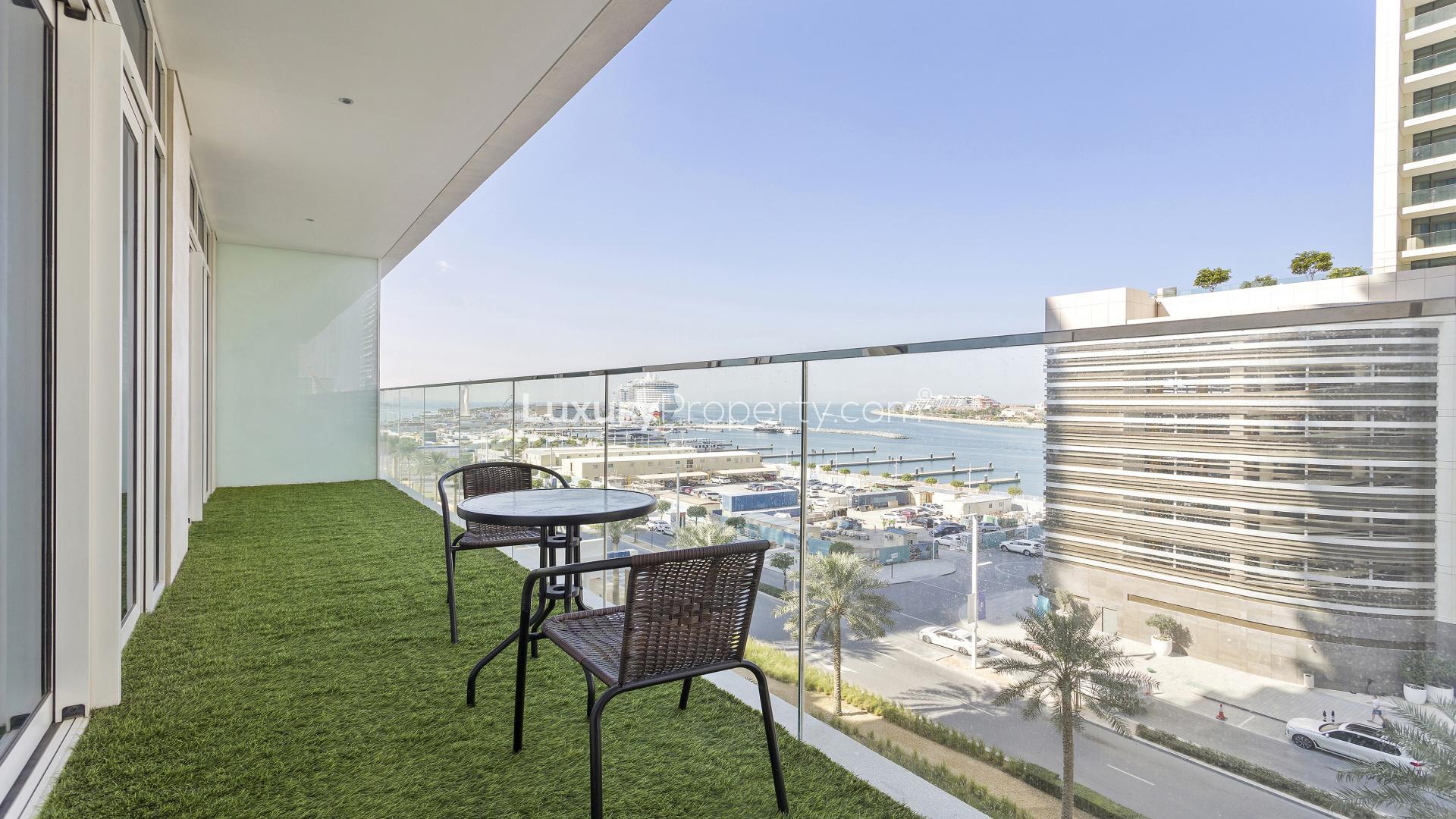 Luxurious open-plan living room and kitchen in Emaar Beachfront apartment, Dubai Harbour