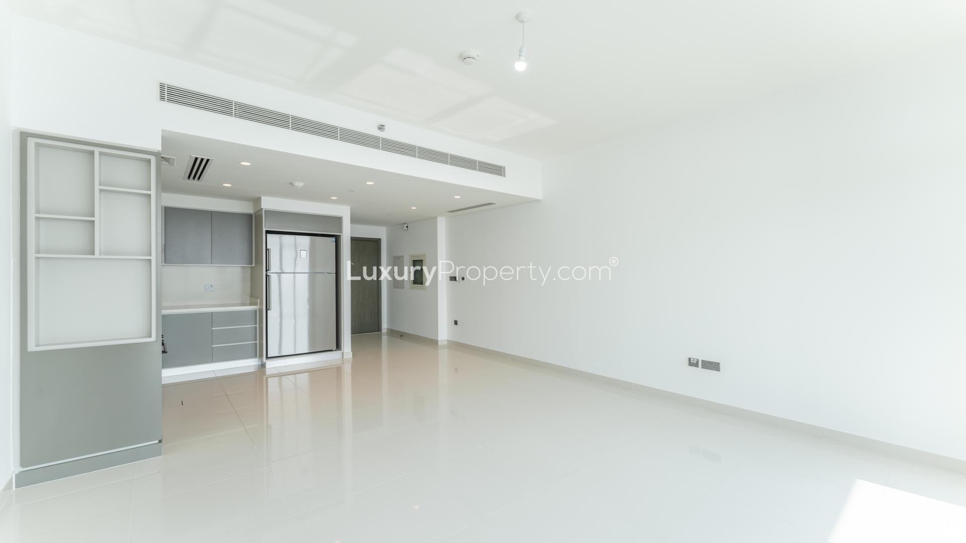 "Balcony view from 2-bed apartment at Emaar Beachfront, overlooking Palm and Marina in Dubai Harbour.",Modern kitchen in 2-bed apartment, Emaar Beachfront, Dubai Harbour, available for rent