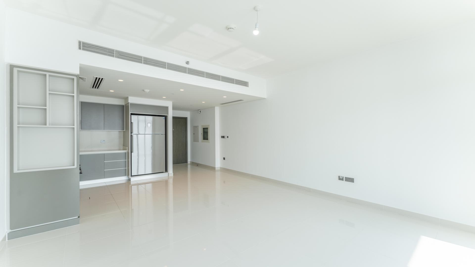 "Balcony view from 2-bed apartment at Emaar Beachfront, overlooking Palm and Marina in Dubai Harbour.",Modern kitchen in 2-bed apartment, Emaar Beachfront, Dubai Harbour, available for rent