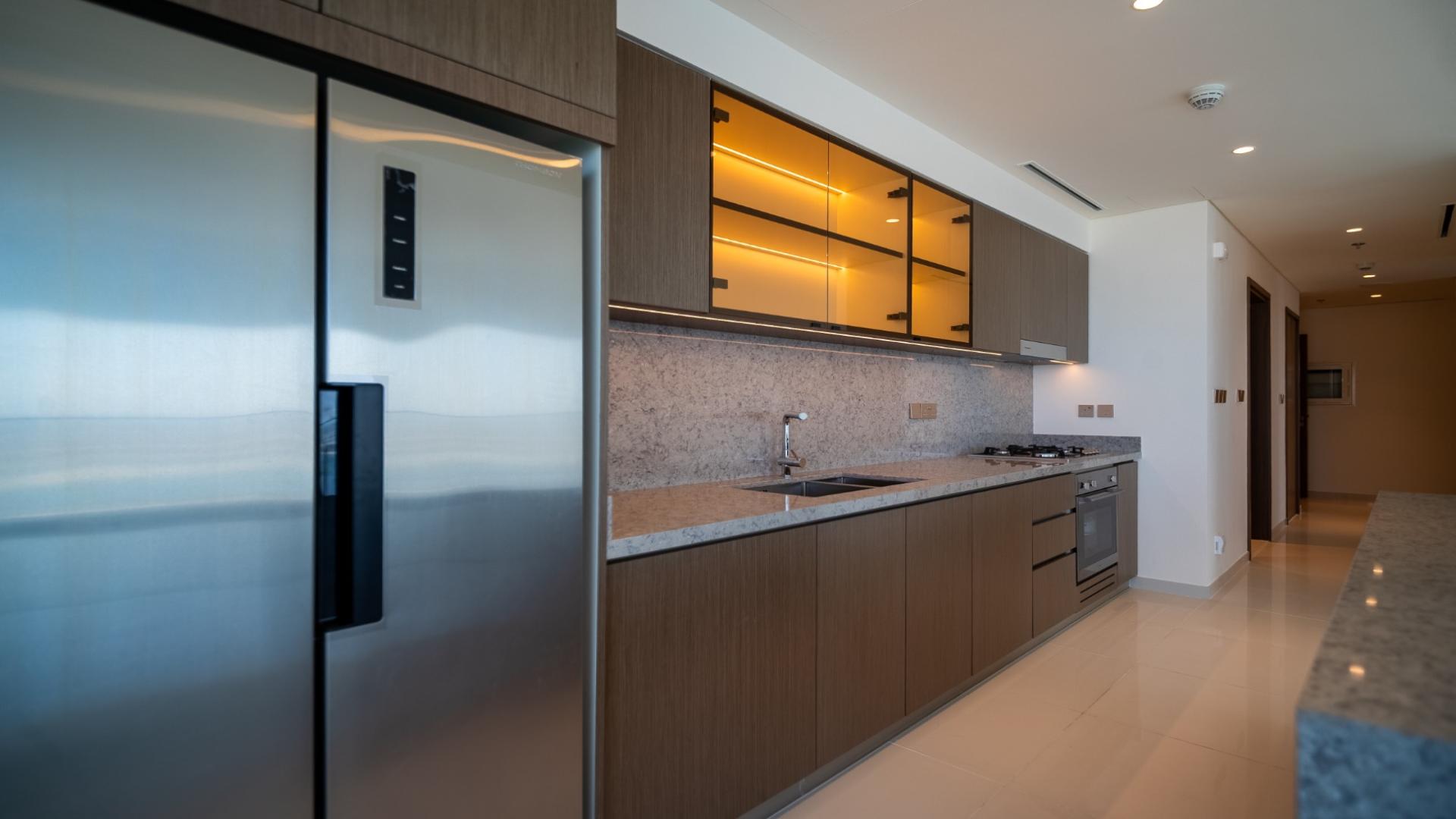 Empty room with large windows and ocean view in Elie Saab Dubai Harbour apartment