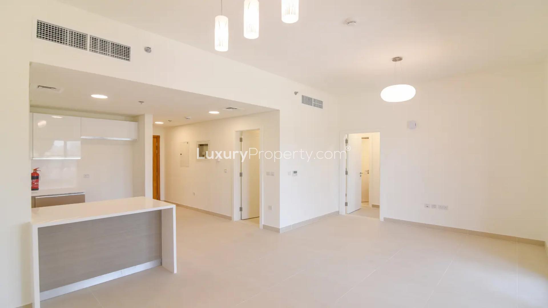 Open-plan kitchen and living area in Al Andalus 2-bedroom apartment