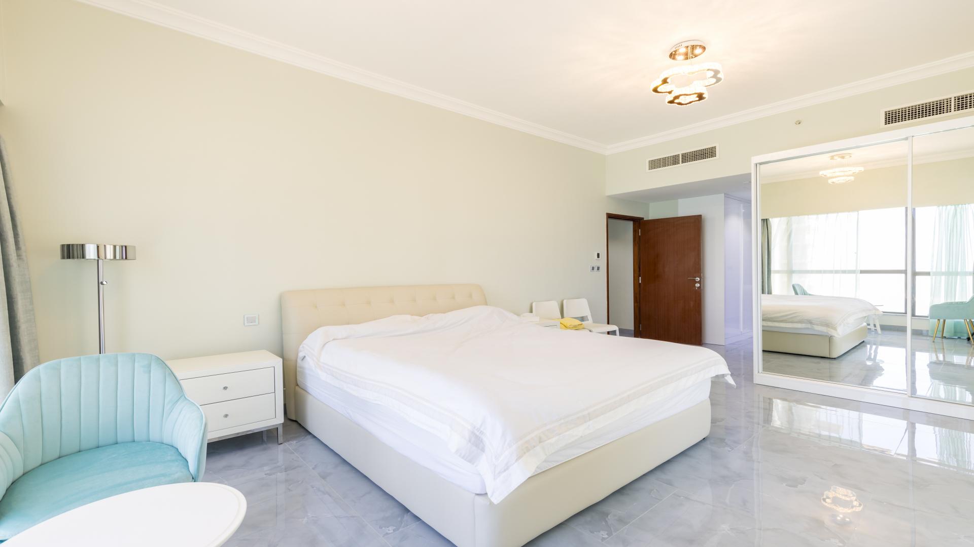 Living area of spacious 2-bedroom apartment in JBR Sadaf with modern furnishings and decor