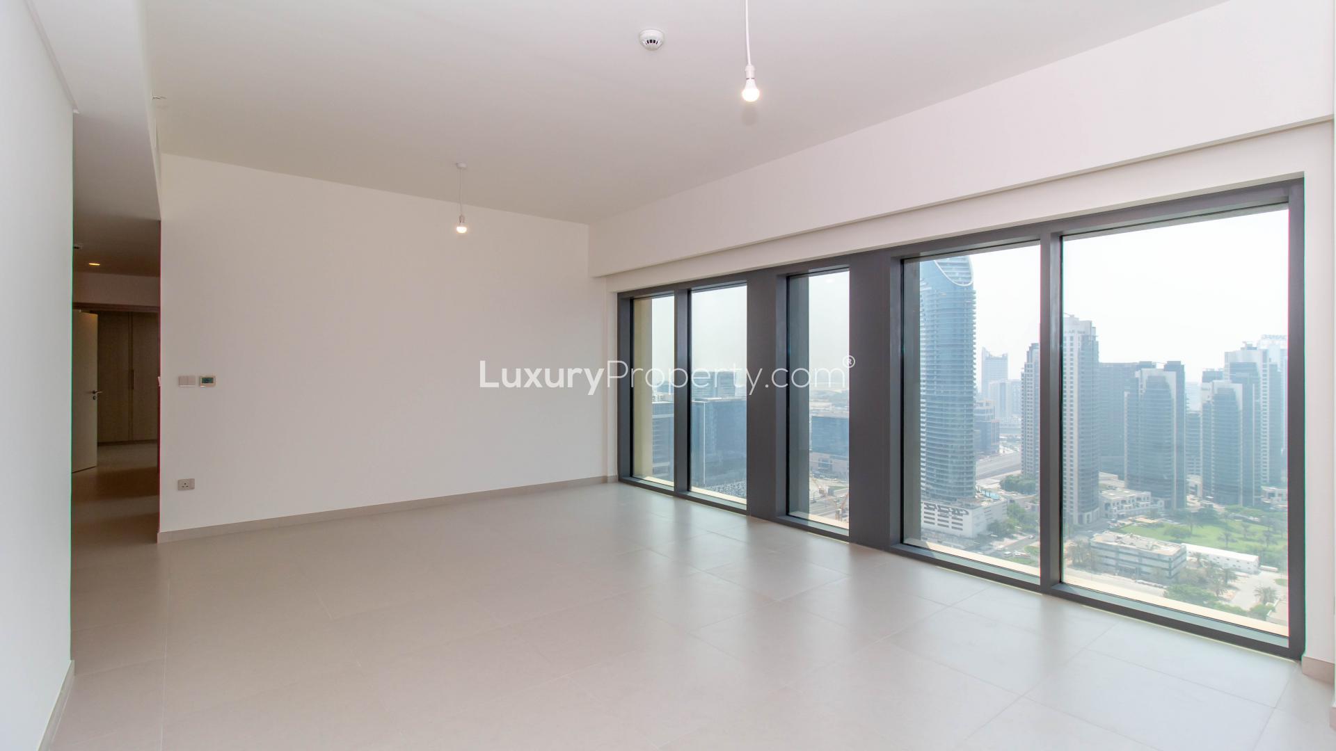 Empty living room with large windows and city view in Burj Royale, Downtown Dubai apartment