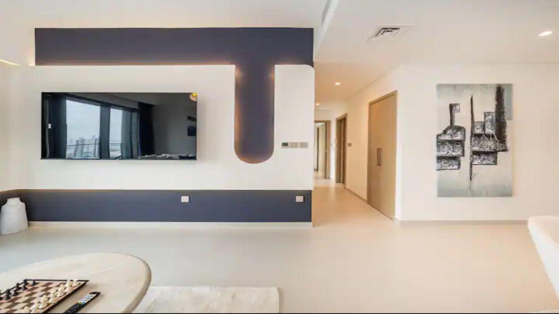 Modern bedroom interior in Burj Royale apartment, Downtown Dubai, featuring stylish decor and TV