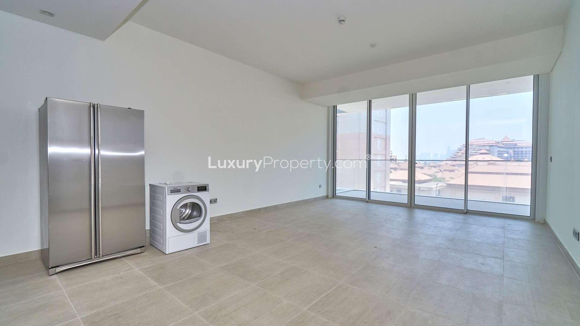 Modern kitchen in Serenia Residences apartment, Palm Jumeirah, featuring sleek cabinetry and appliances