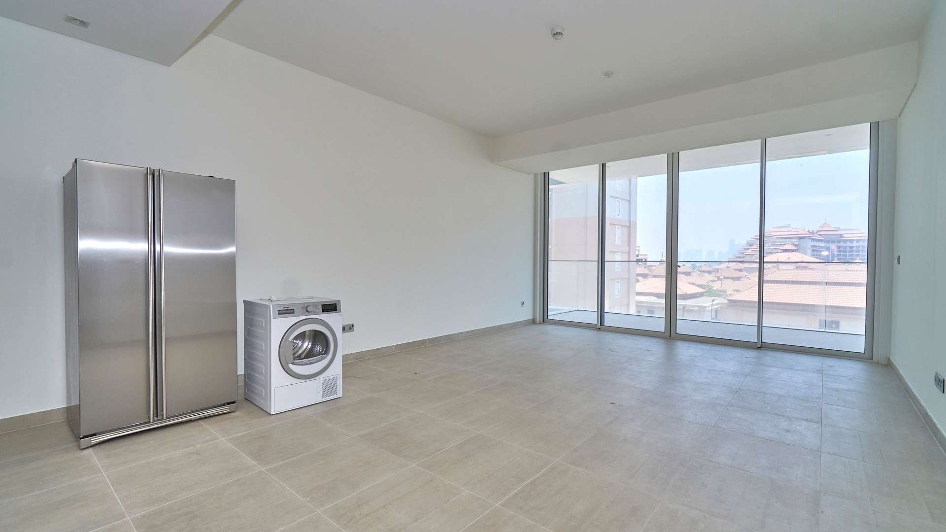 Modern kitchen in Serenia Residences apartment, Palm Jumeirah, featuring sleek cabinetry and appliances