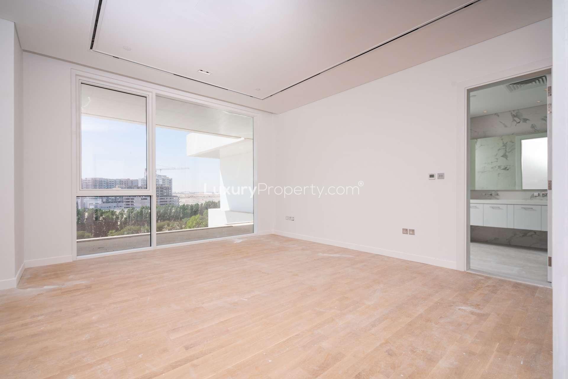 "Spacious balcony with scenic views in Seventh Heaven, Al Barari apartment for rent.",Modern living room with large window in Seventh Heaven apartment, Al Barari