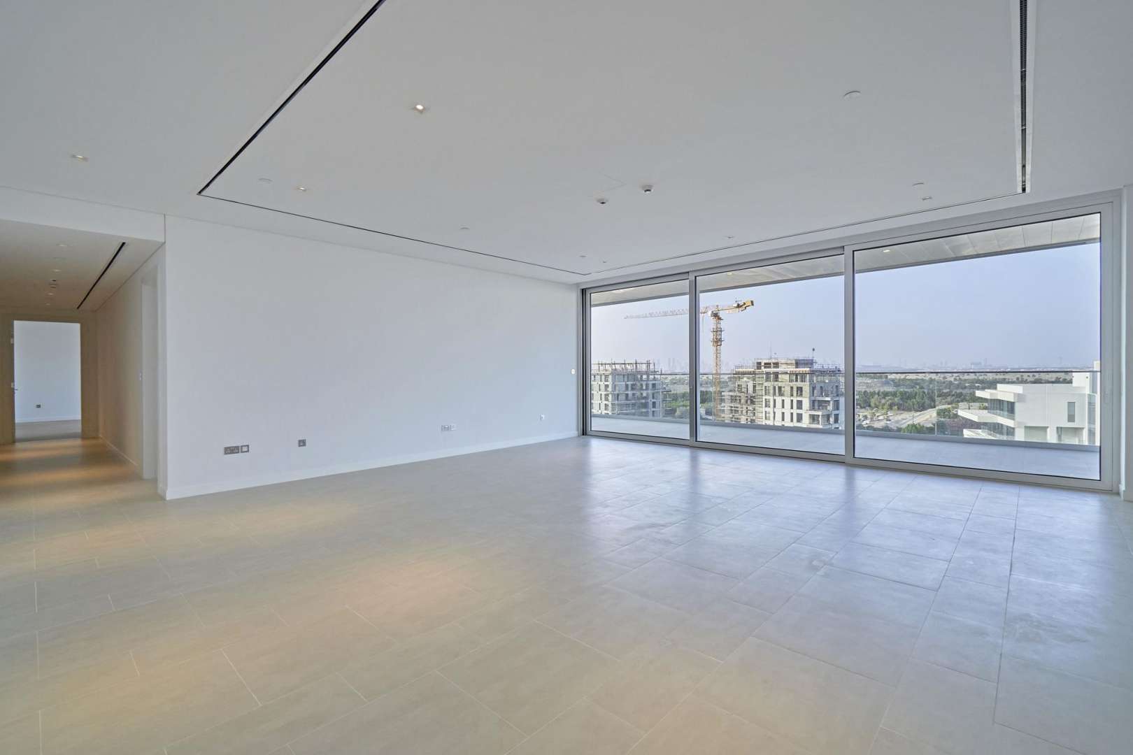 Night view of Seventh Heaven apartment complex, Al Barari, featuring modern architecture and greenery