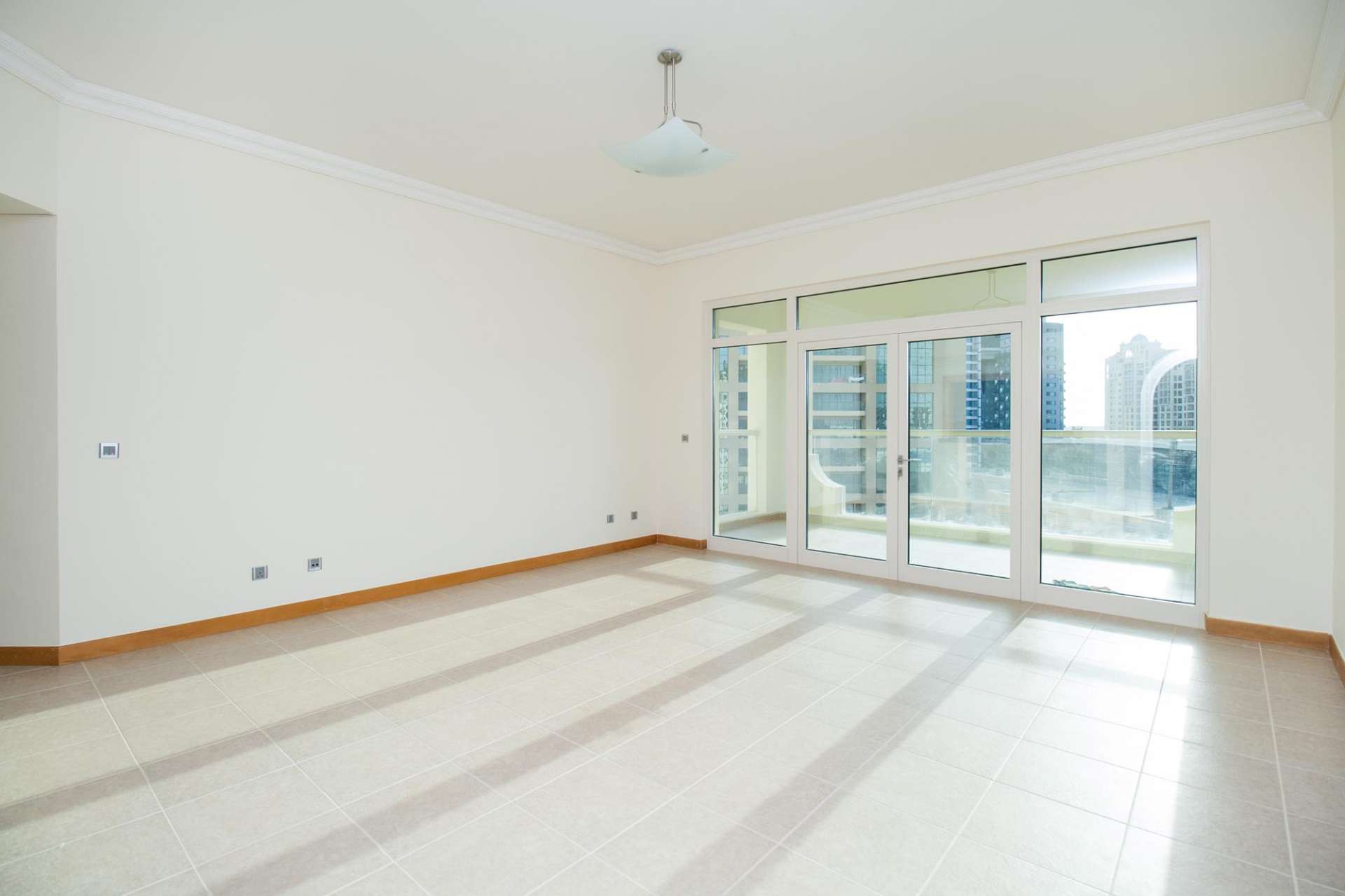 Spacious kitchen in 2-bedroom apartment, Shoreline Residences, Palm Jumeirah, with modern wood cabinets