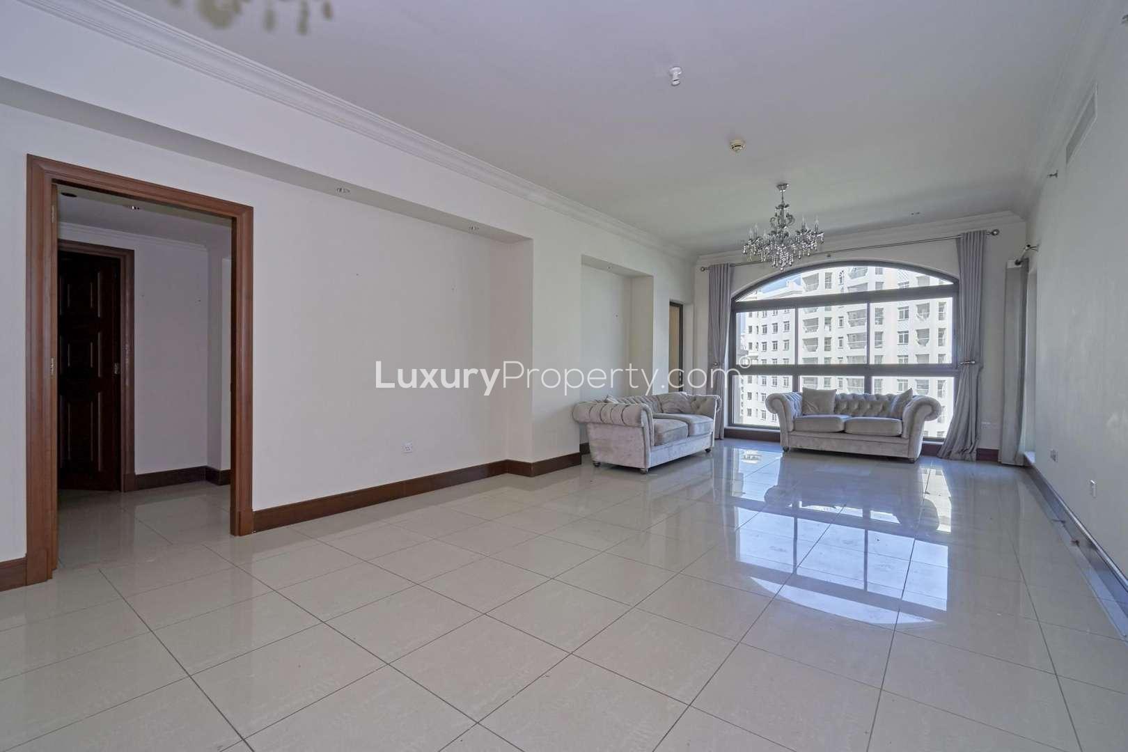 Bright living room in 2-bedroom apartment, Shoreline, Palm Jumeirah, with elegant sofas and chandelier