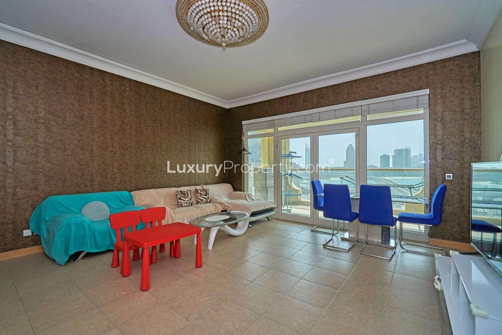 Exterior view of Shoreline Apartments, Palm Jumeirah, showcasing grand entrance and lush greenery