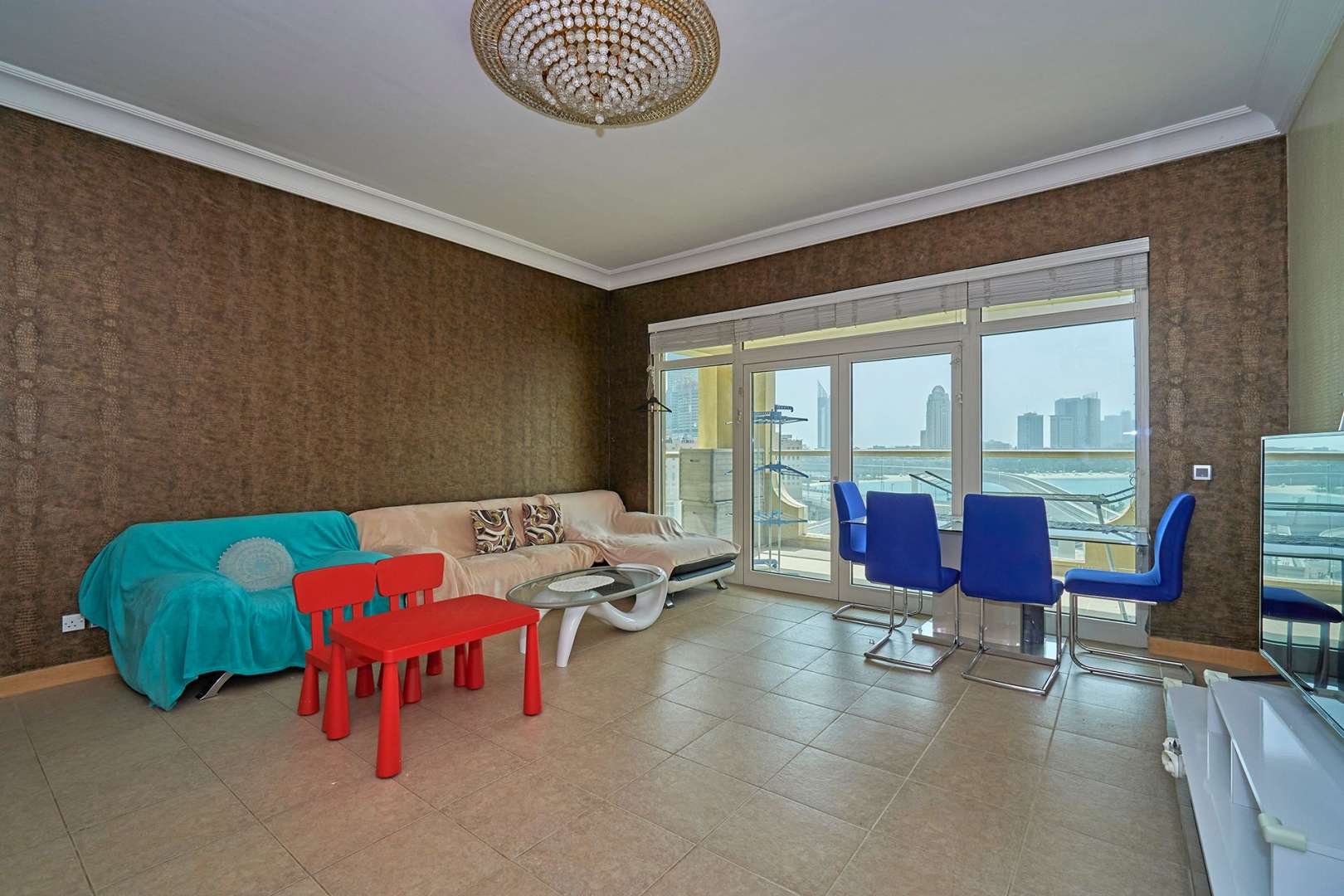 Exterior view of Shoreline Apartments, Palm Jumeirah, showcasing grand entrance and lush greenery