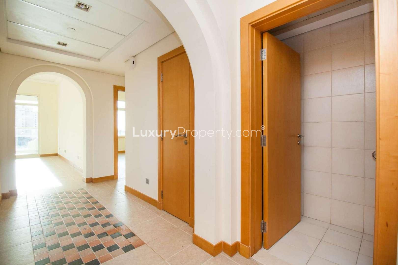 Spacious living room with large windows in Shoreline Residences apartment, Palm Jumeirah