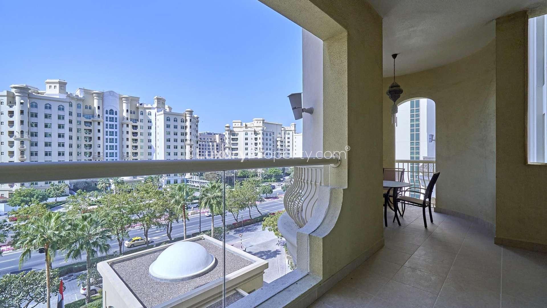 Living room of two-bedroom apartment in Shoreline, Palm Jumeirah with balcony view