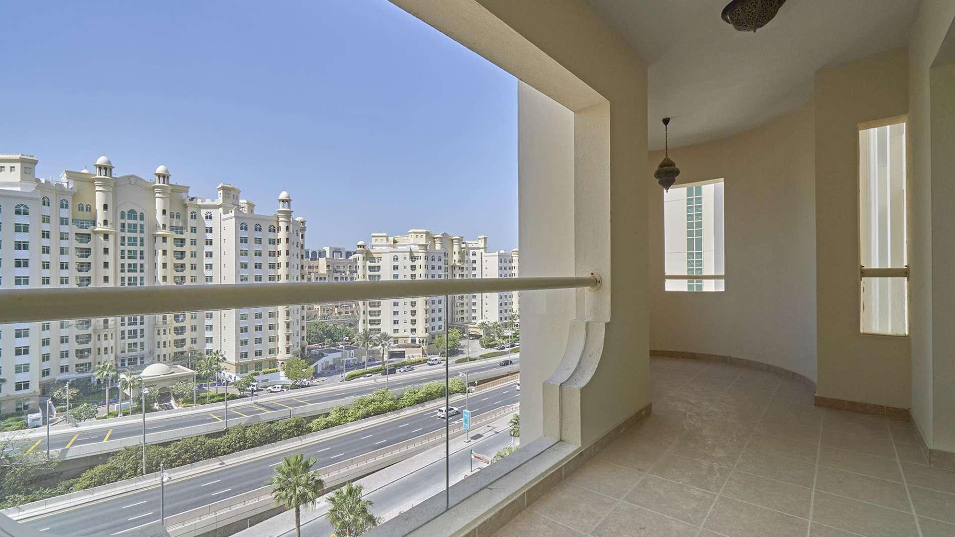 Empty living room in Shoreline Apartments, Palm Jumeirah with garden view balcony