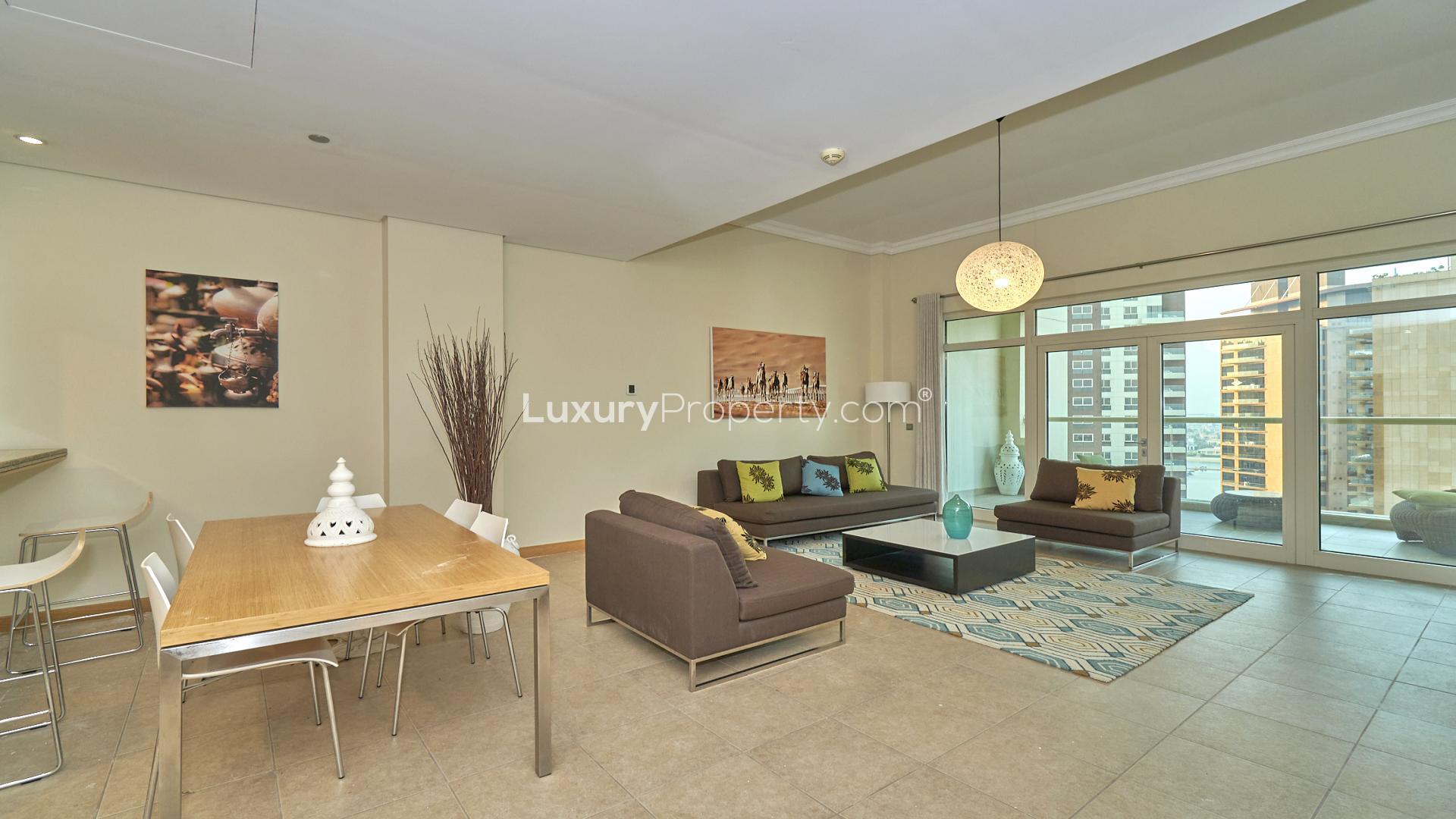 Fully furnished living room in Palm Jumeirah apartment with balcony and city views