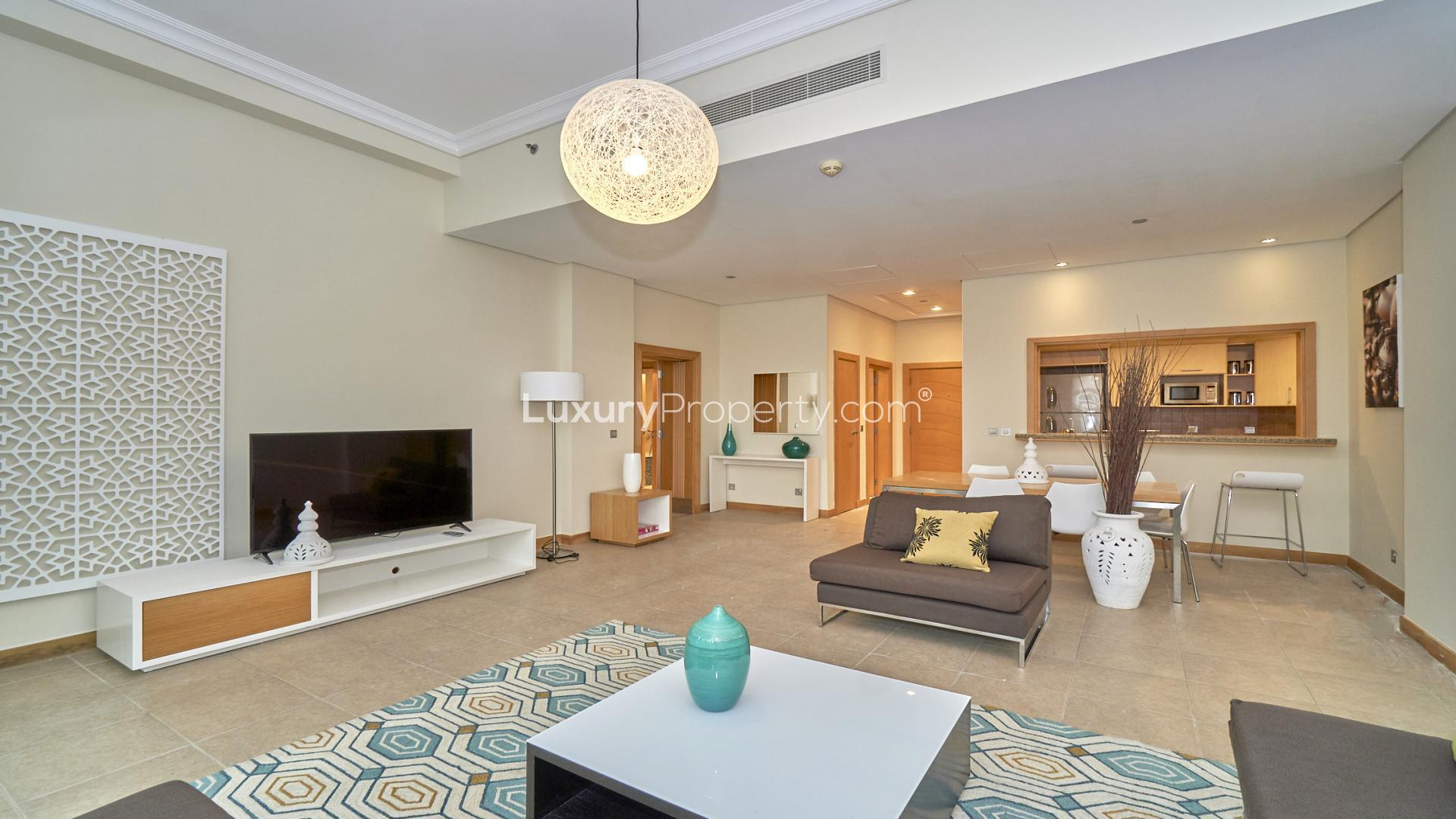 "Balcony view from furnished Shoreline Apartment, Palm Jumeirah, with modern seating and sea glimpse.","Spacious living room in fully furnished Shoreline Apartment, Palm Jumeirah, Dubai for rent.",Fully furnished living and dining area in Shoreline Apartment, Palm Jumeirah, for rent