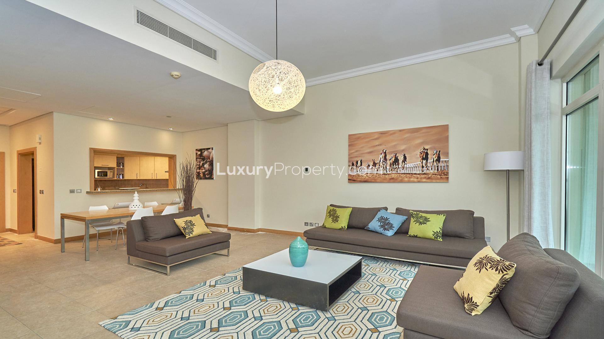 Fully furnished living room in Shoreline Apartment, Palm Jumeirah, with modern decor and balcony
