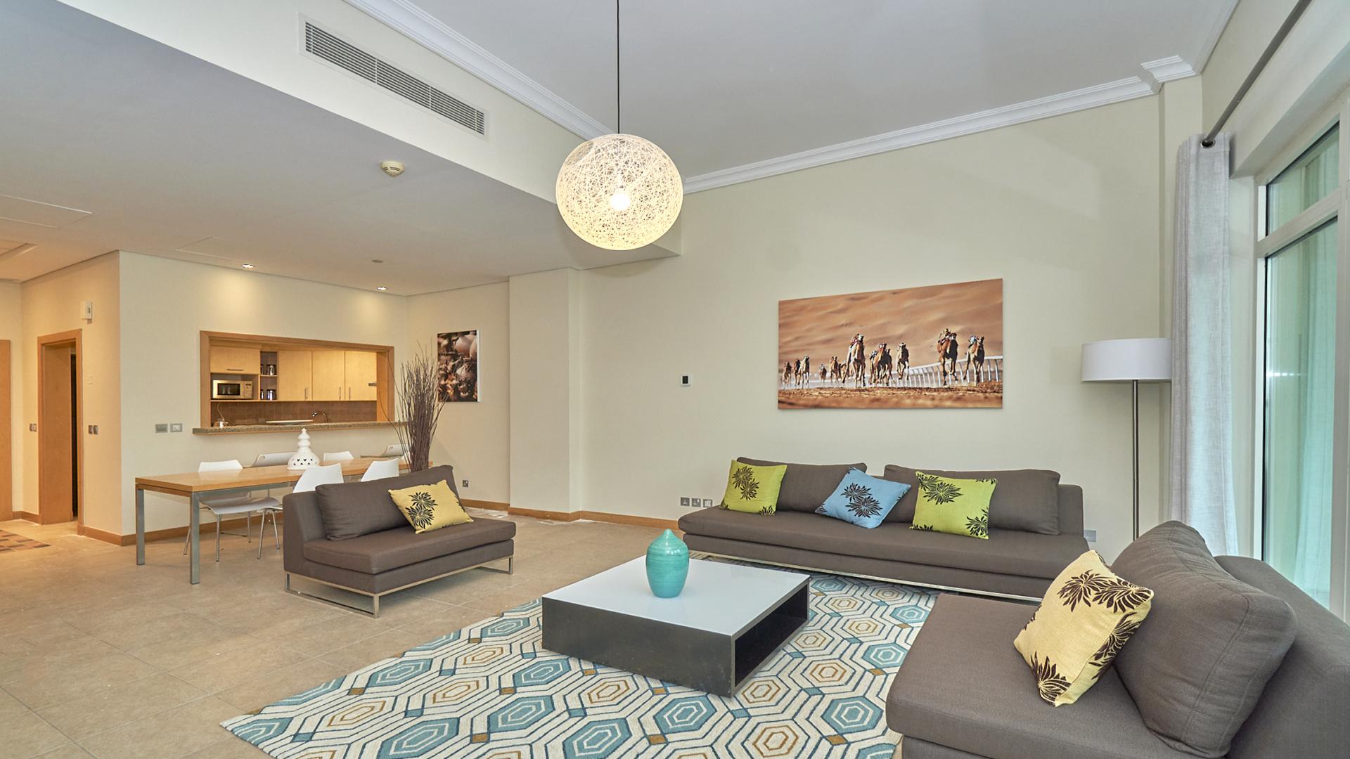 Fully furnished living room in Shoreline Apartment, Palm Jumeirah, with modern decor and balcony