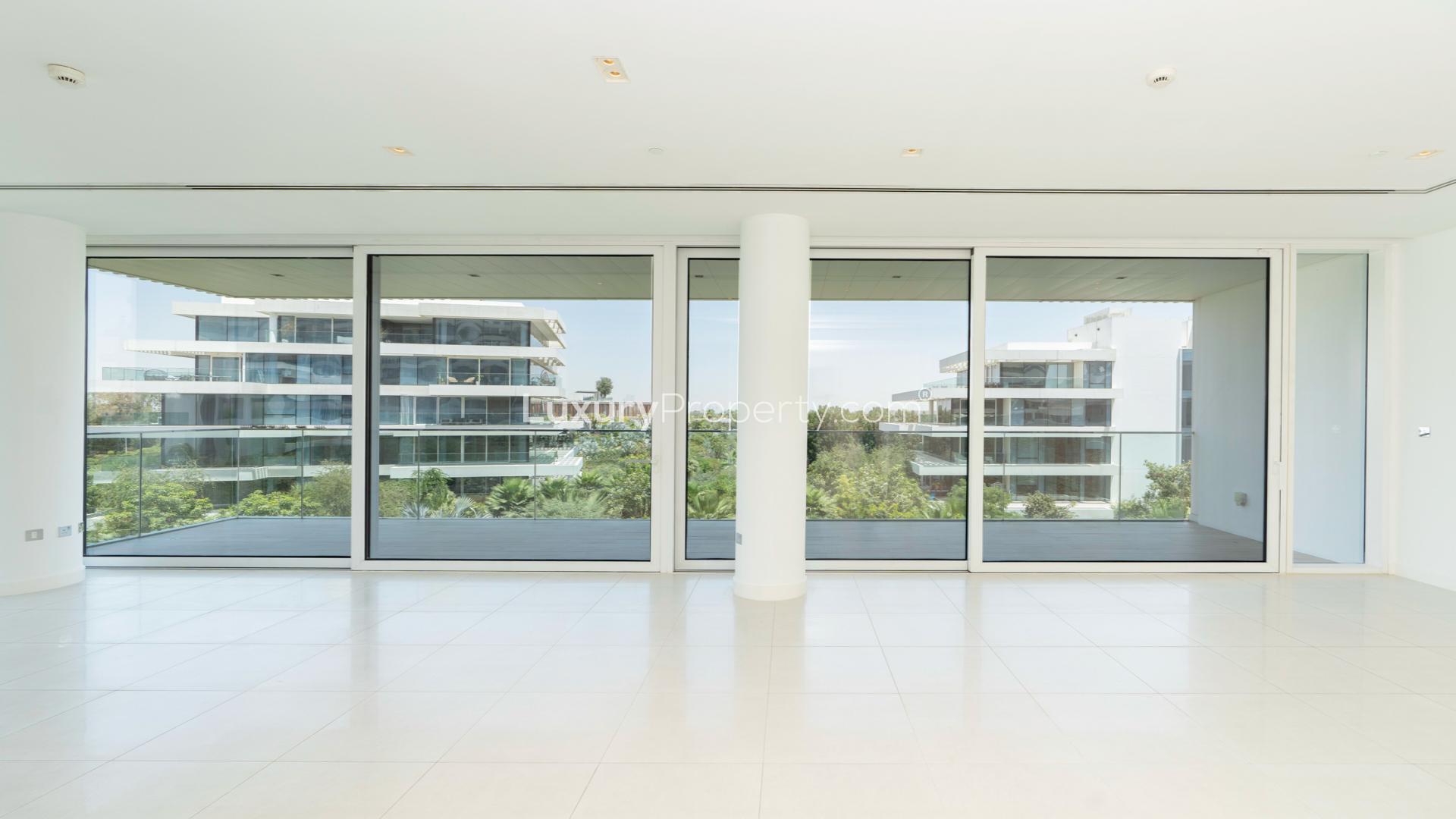 Modern kitchen in high-end Ashjar apartment, Al Barari, with pool view and sleek design