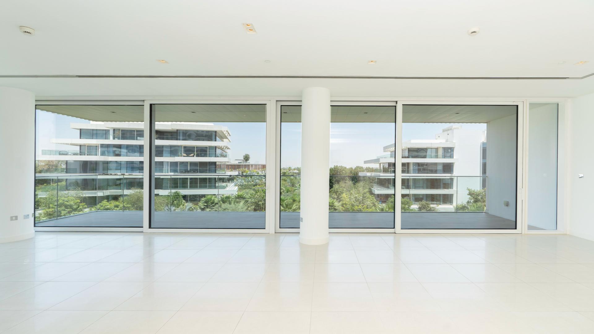 Modern kitchen in high-end Ashjar apartment, Al Barari, with pool view and sleek design