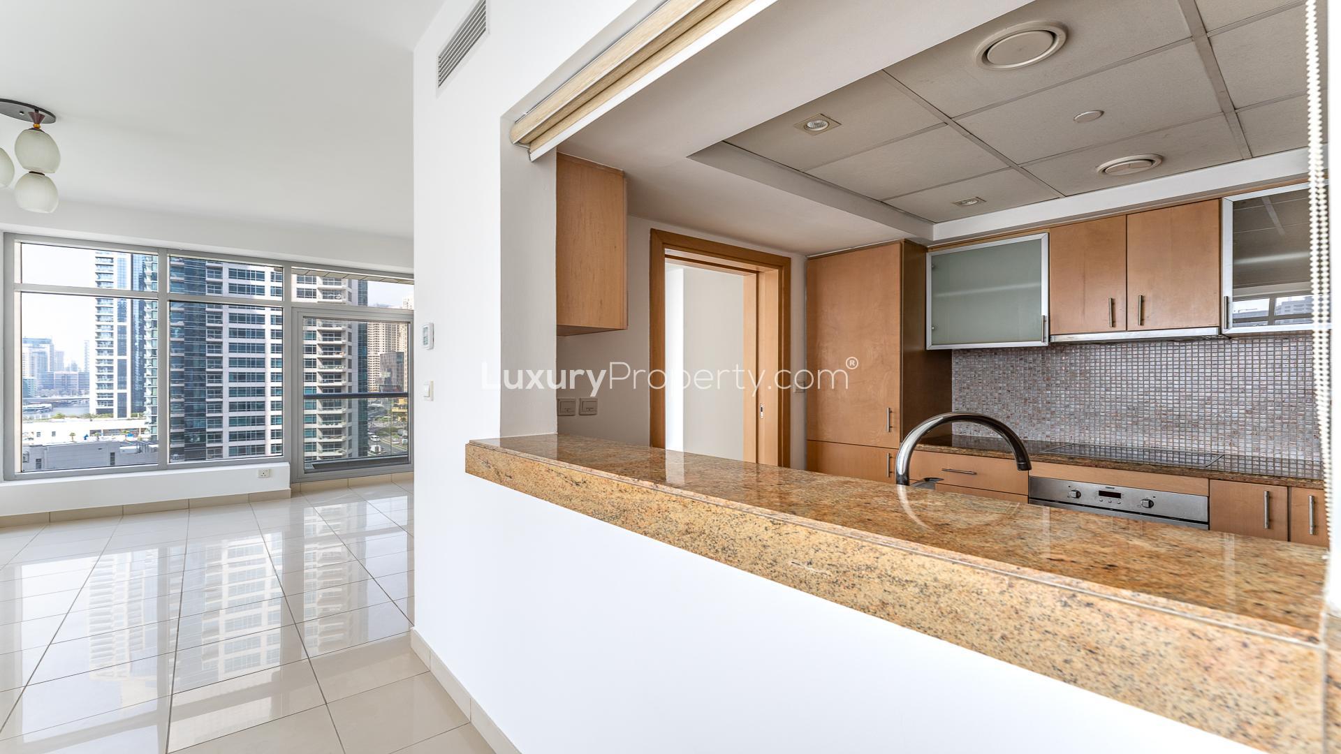 "View from Blakely Tower apartment balcony overlooking Dubai Marina skyline and waterfront.",Chiller-free apartment kitchen and living area in Blakely Tower, Dubai Marina, Park Island