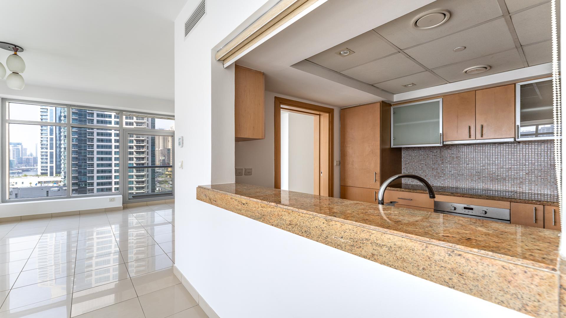 "View from Blakely Tower apartment balcony overlooking Dubai Marina skyline and waterfront.",Chiller-free apartment kitchen and living area in Blakely Tower, Dubai Marina, Park Island