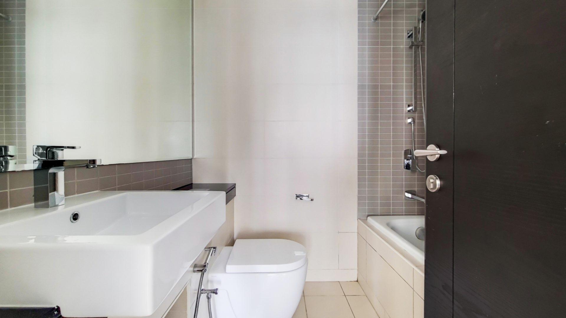 Modern twin bedroom in Silverene Towers apartment, Dubai Marina, with large window and elegant decor