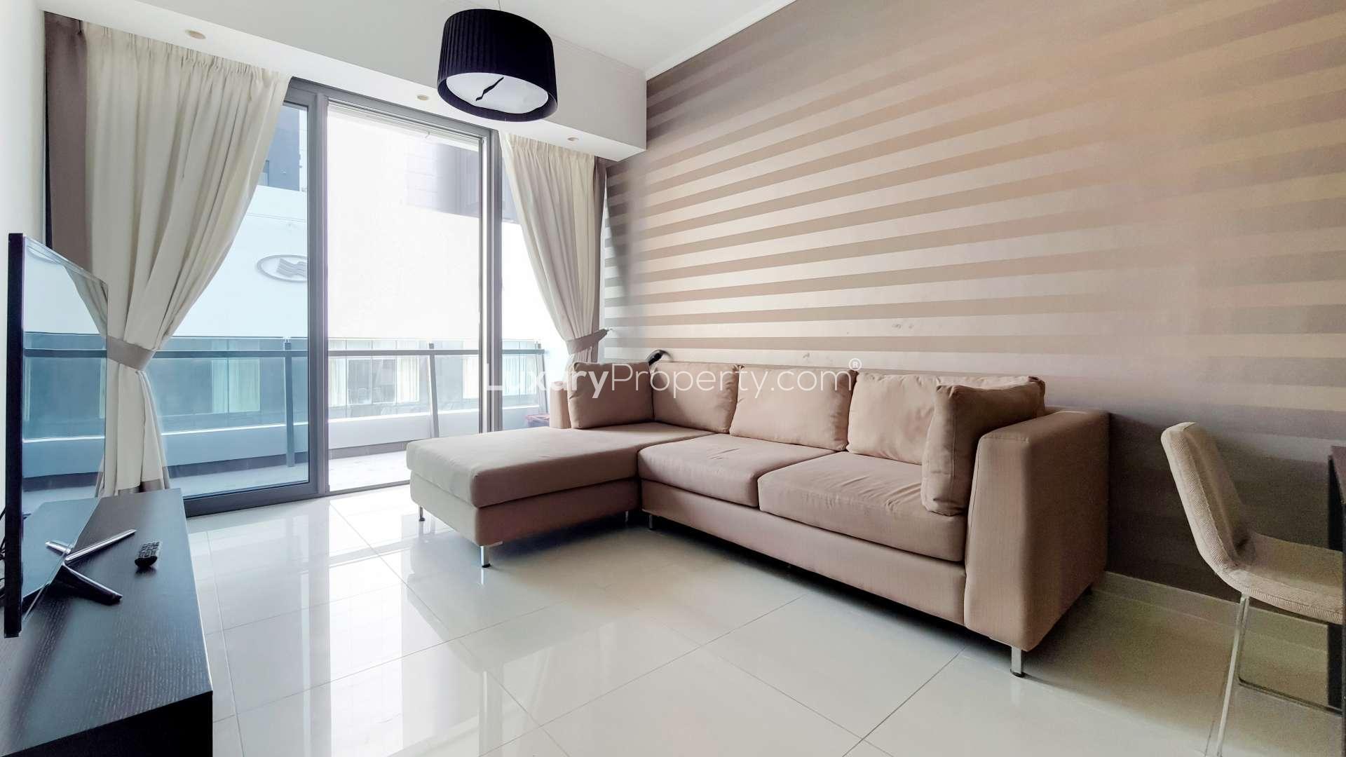 Furnished living room in high-floor Dubai Marina apartment, Silverene, with modern decor and TV